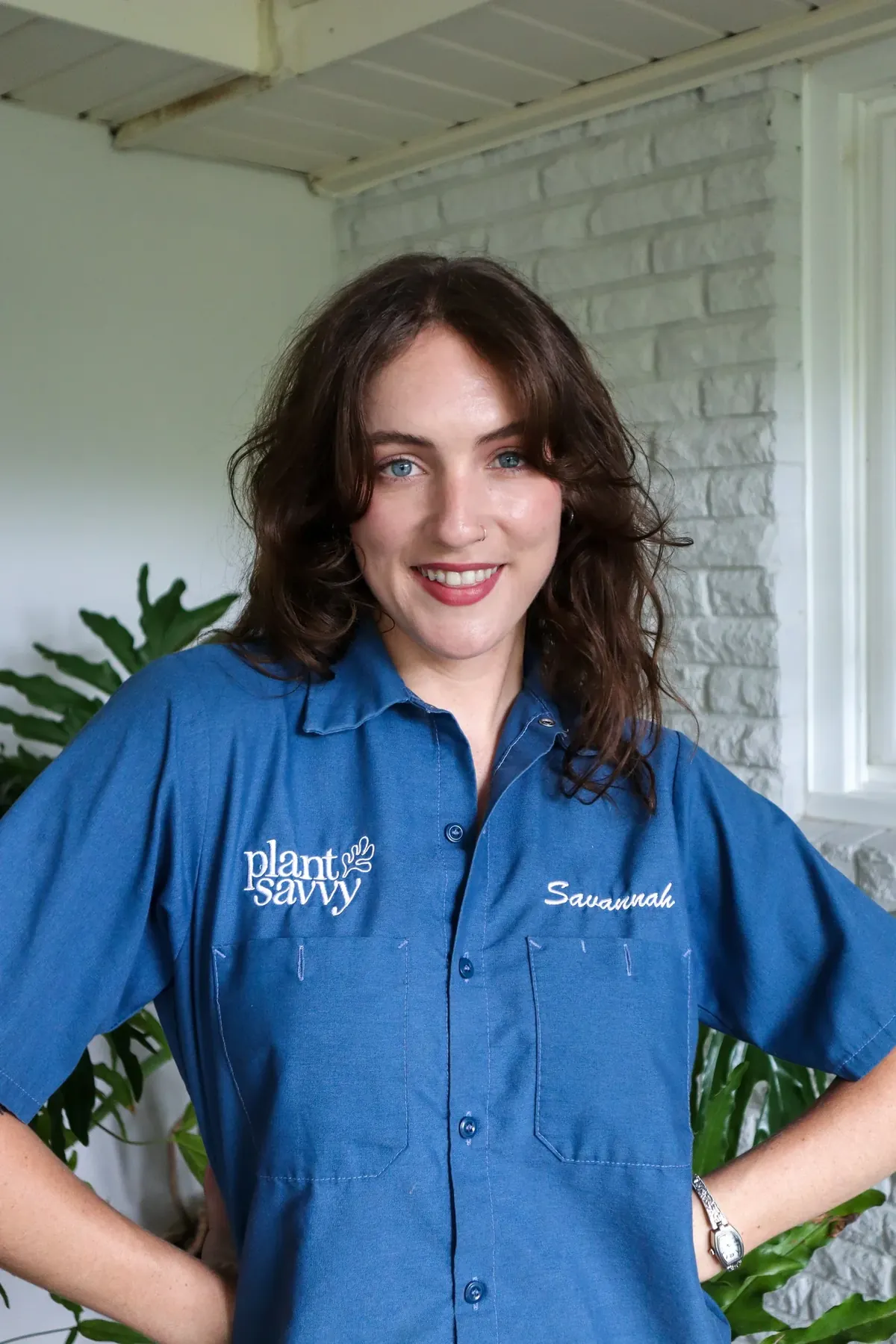 Savannah Toal, founder of Plant Savvy, surrounded by houseplants